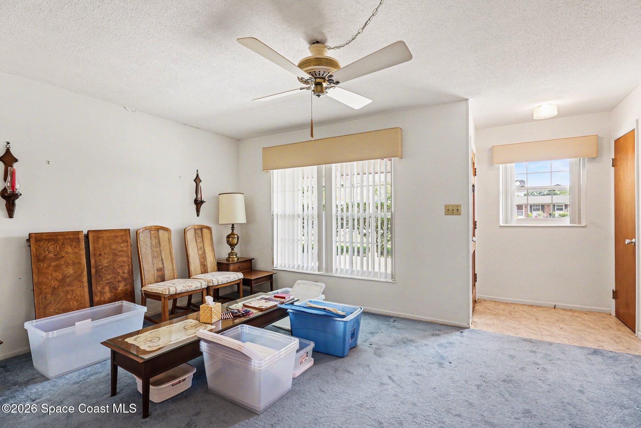 979 Kings Post Road Rockledge, FL 32955 - Photo 3 of 15 a living room with furniture and a chandelier
