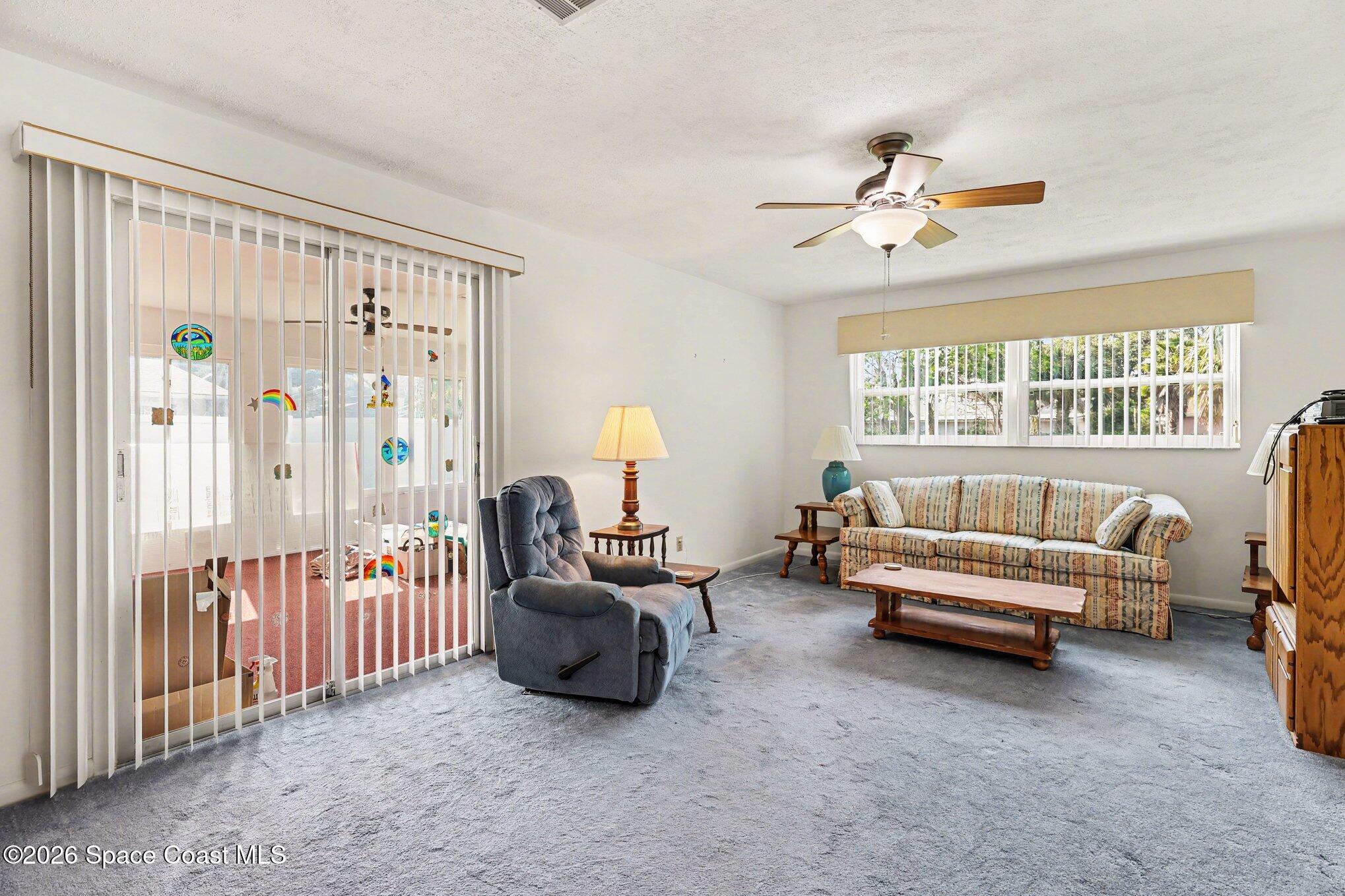 979 Kings Post Road Rockledge, FL 32955 - Photo 4 of 15 a living room with furniture and a large window