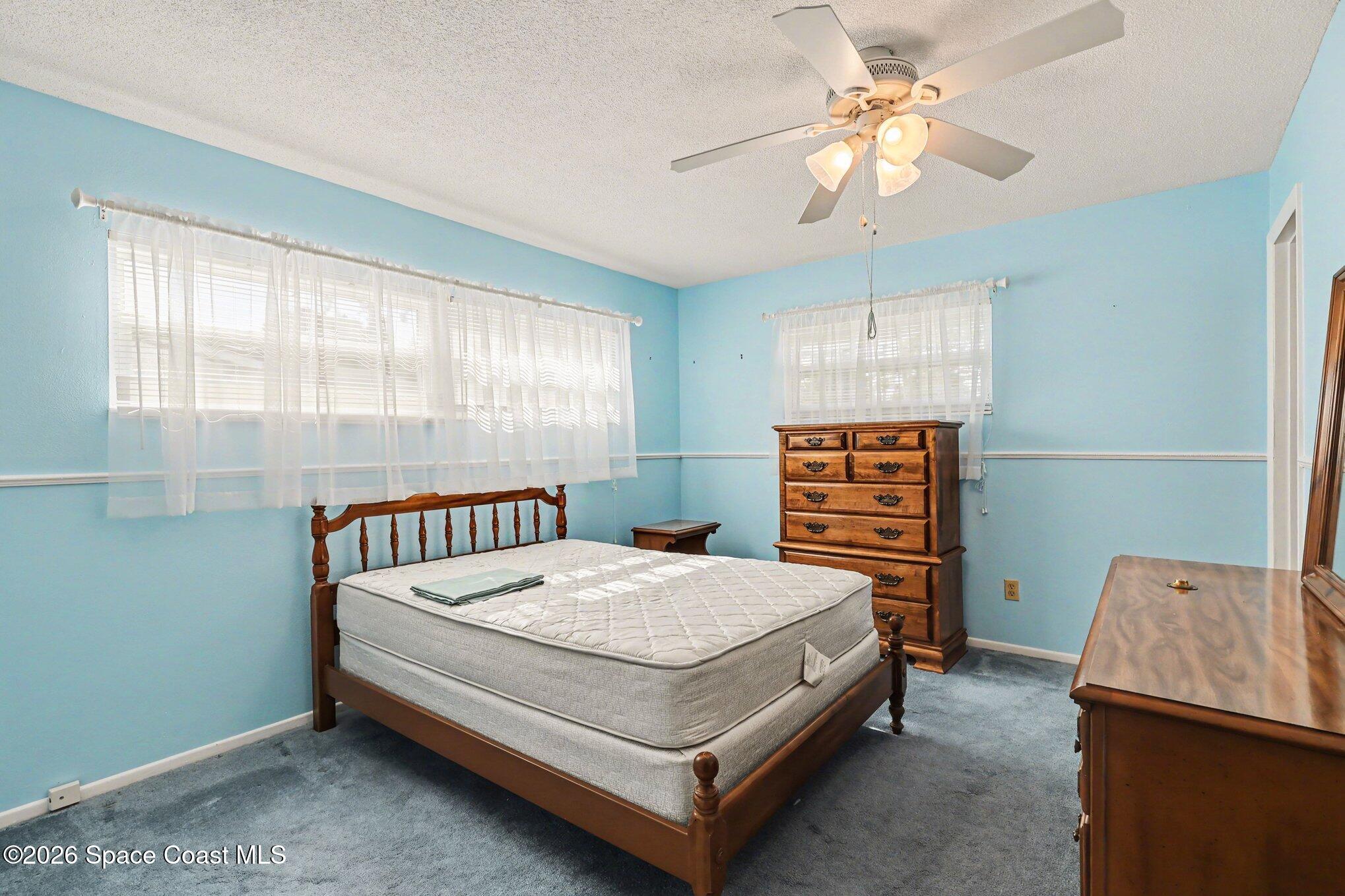979 Kings Post Road Rockledge, FL 32955 - Photo 10 of 15 a bed sitting in a bedroom next to a window