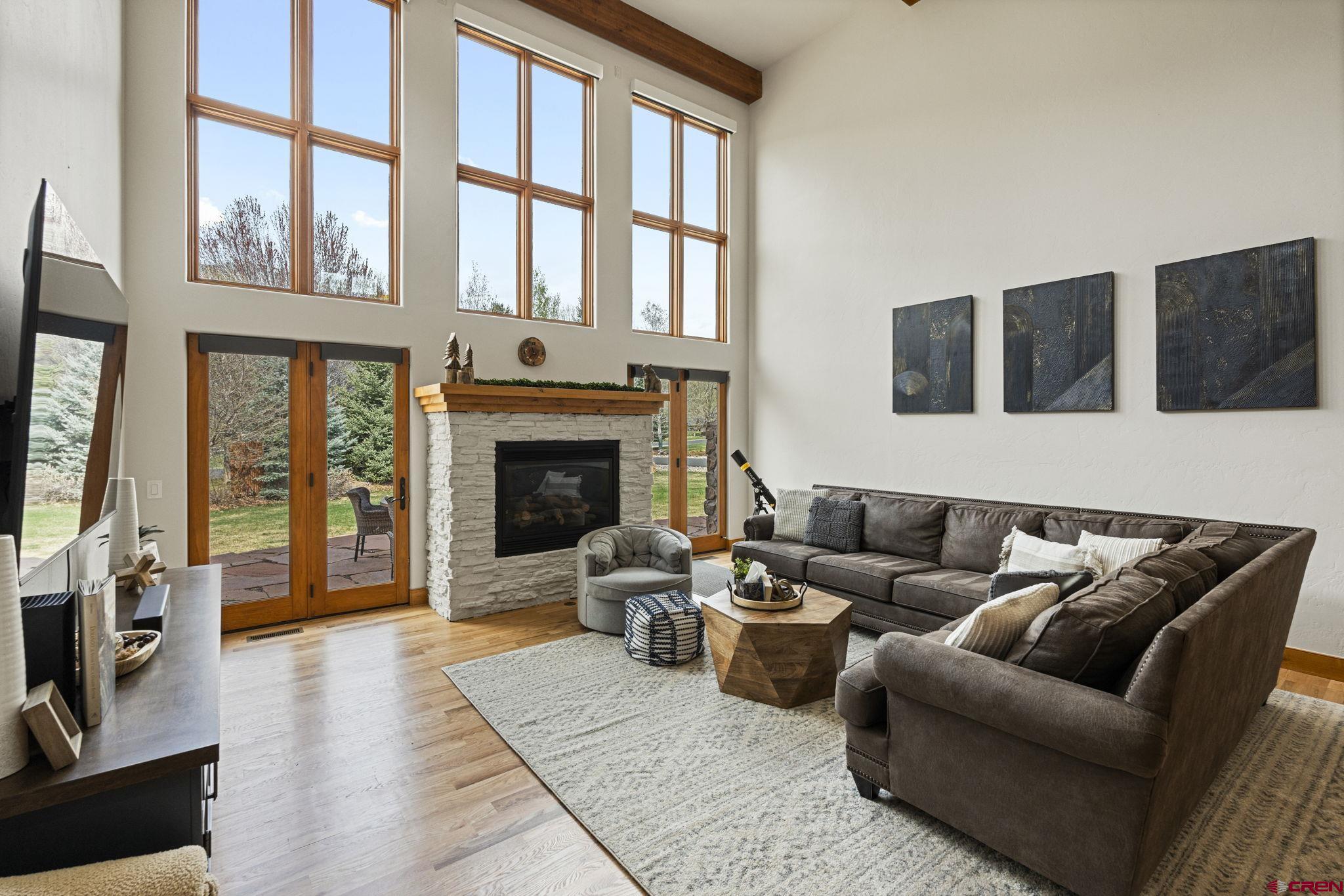 a living room with furniture fireplace and flat screen tv