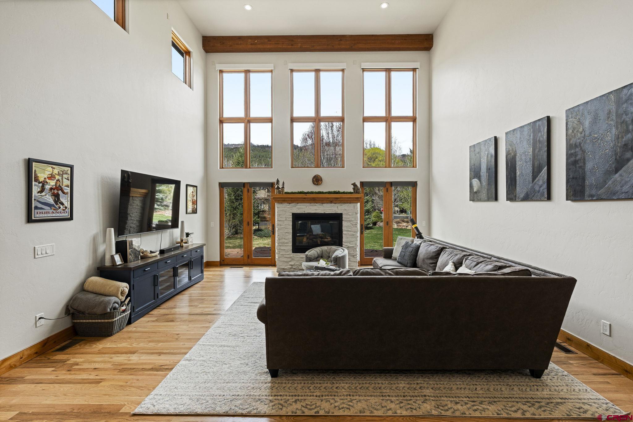 95 Turnberry Drive Durango, CO 81301 - Photo 12 of 36 a living room with furniture large window and a fireplace