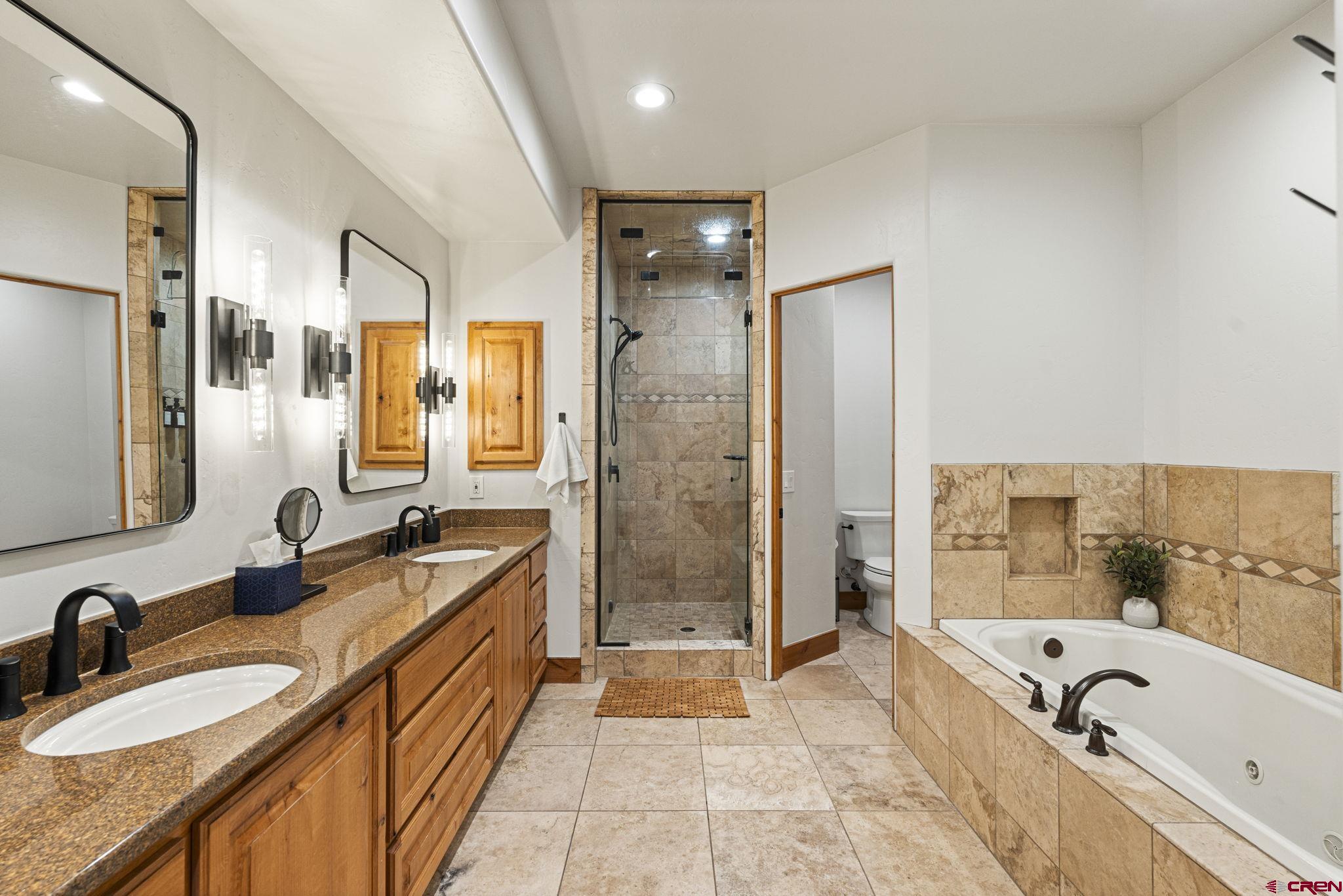 95 Turnberry Drive Durango, CO 81301 - Photo 19 of 36 a bathroom with a tub sink shower and mirror