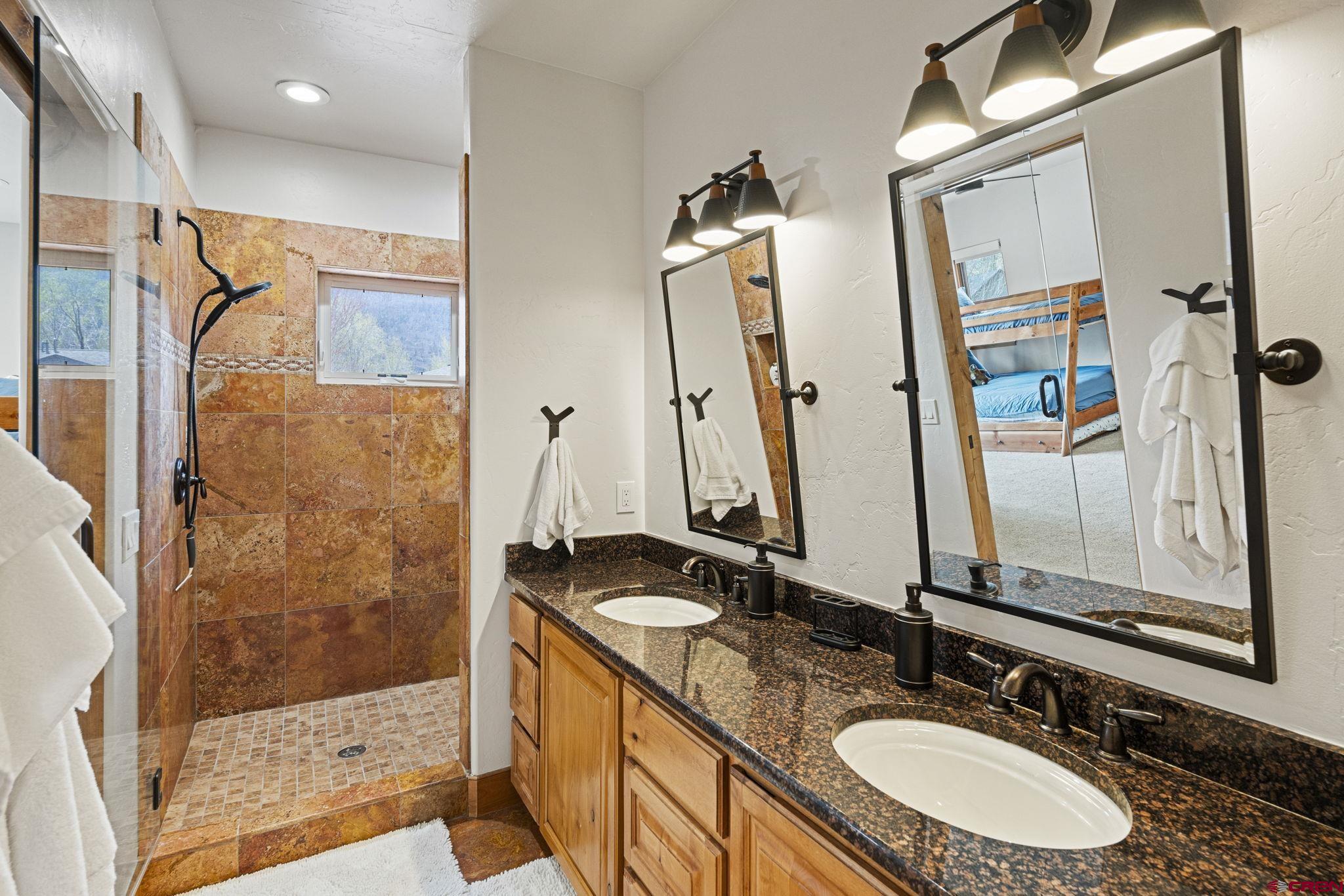 95 Turnberry Drive Durango, CO 81301 - Photo 23 of 36 a bathroom with double vanity sink and a mirror