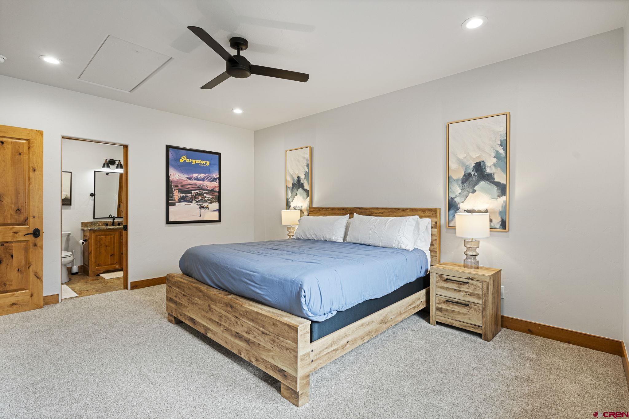 95 Turnberry Drive Durango, CO 81301 - Photo 24 of 36 a bedroom with a bed and a chandelier