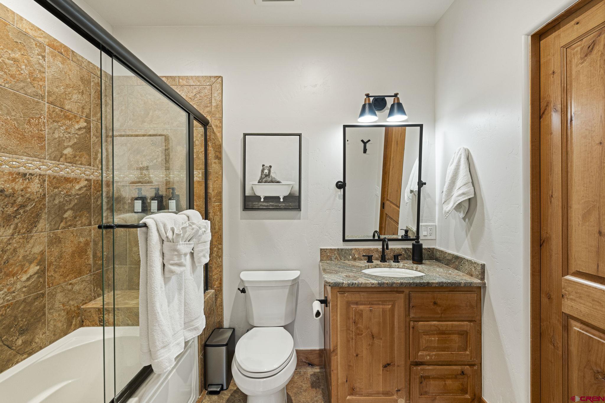 95 Turnberry Drive Durango, CO 81301 - Photo 25 of 36 a bathroom with a toilet a sink and a large mirror