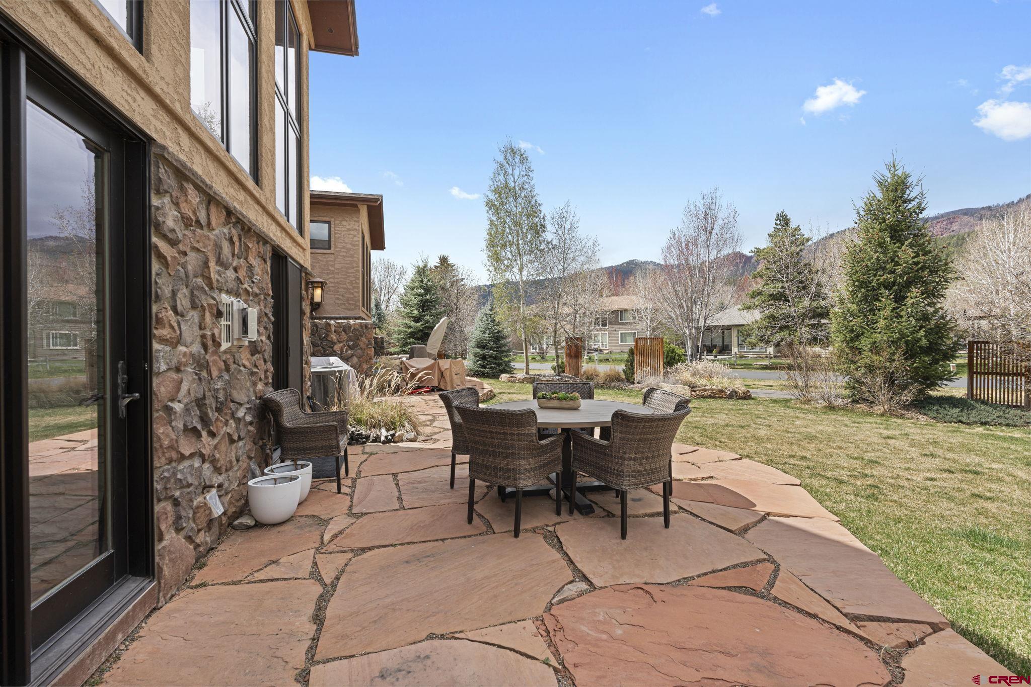 95 Turnberry Drive Durango, CO 81301 - Photo 29 of 36 a view of a patio with couches table and chairs and potted plants
