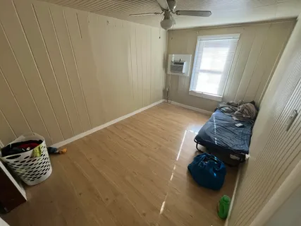 a view of an empty room and wooden floor