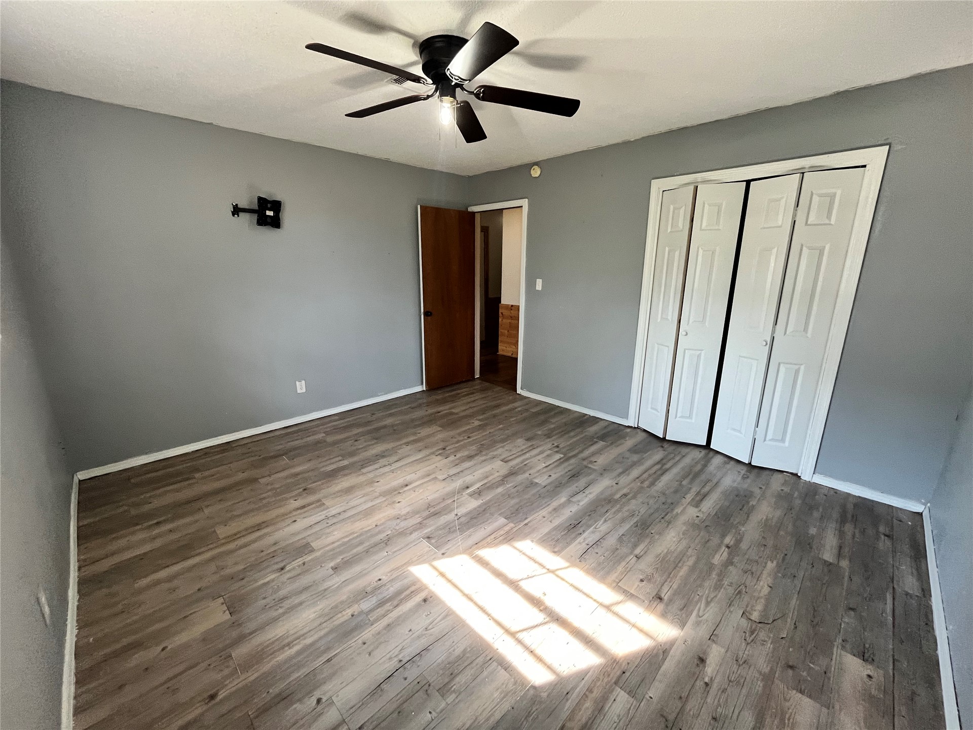 11131 215th Road Nowata, OK 74048 - Photo 22 of 47 From corner looking back toward hallway. Wood-finish flooring with a ceiling fan light fixture