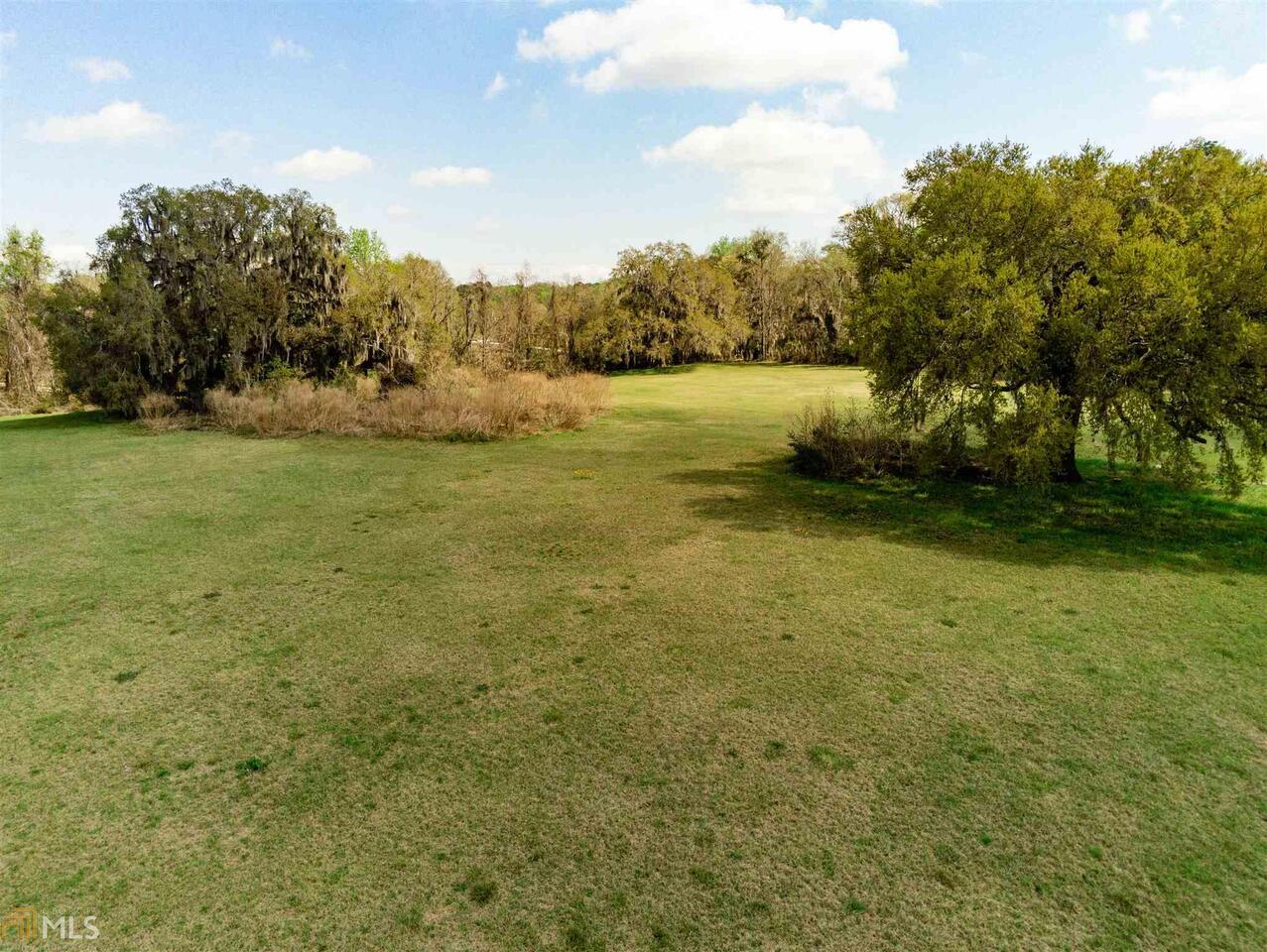 326 Buckhalter Road Savannah, GA 31405 - Photo 1 of 1 a view of a field with an trees