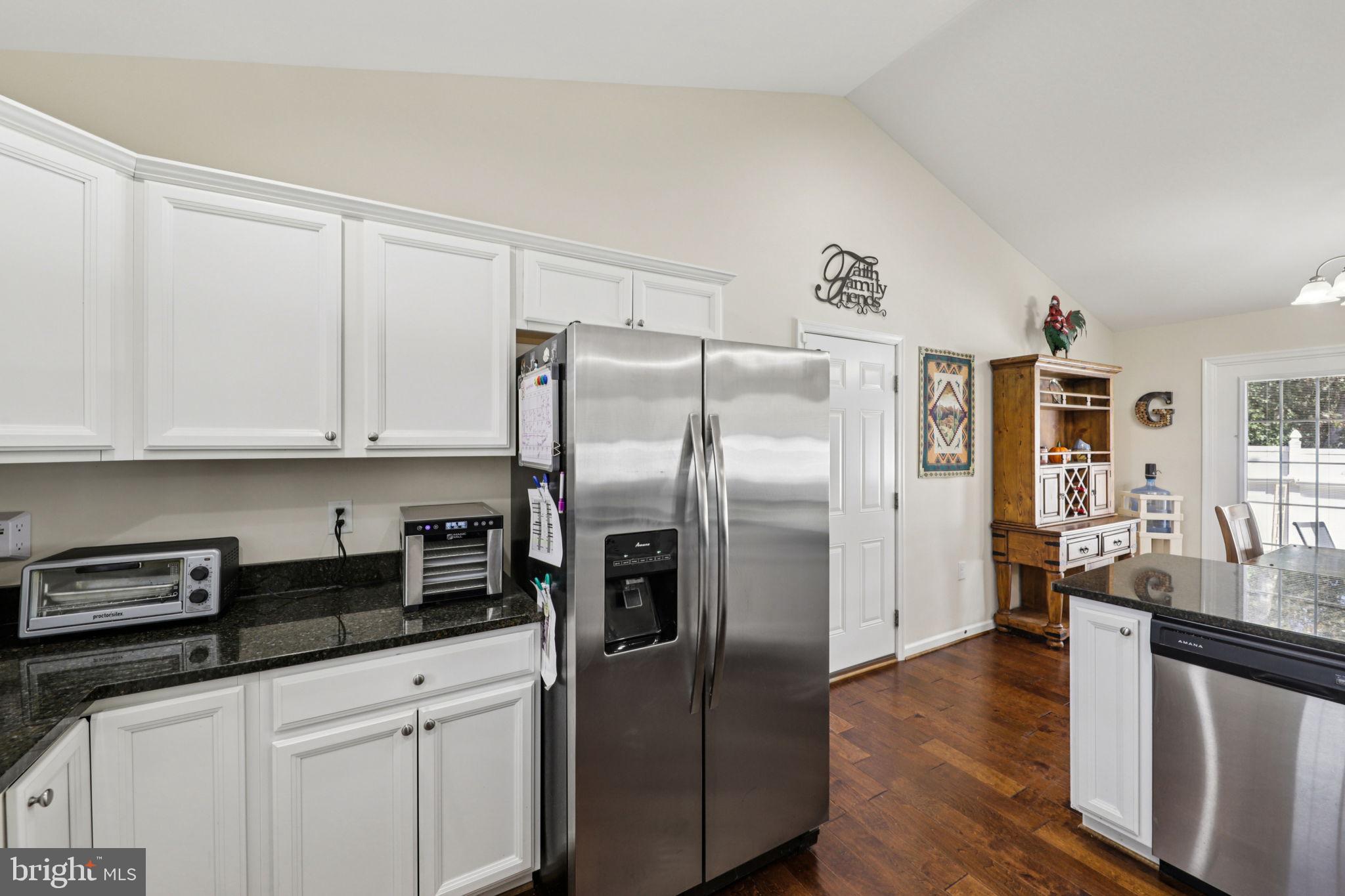 268 Shannon Court Inwood, WV 25428 - Photo 11 of 26 a kitchen with stainless steel appliances granite countertop a refrigerator a sink a stove and white cabinets with wooden floor