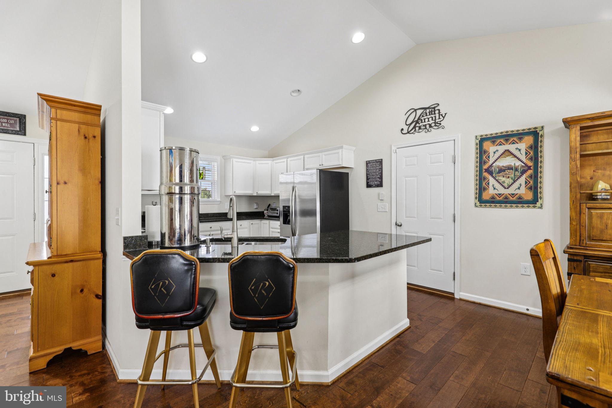 268 Shannon Court Inwood, WV 25428 - Photo 8 of 26 a kitchen with stainless steel appliances granite countertop a refrigerator and a stove top oven with wooden floor