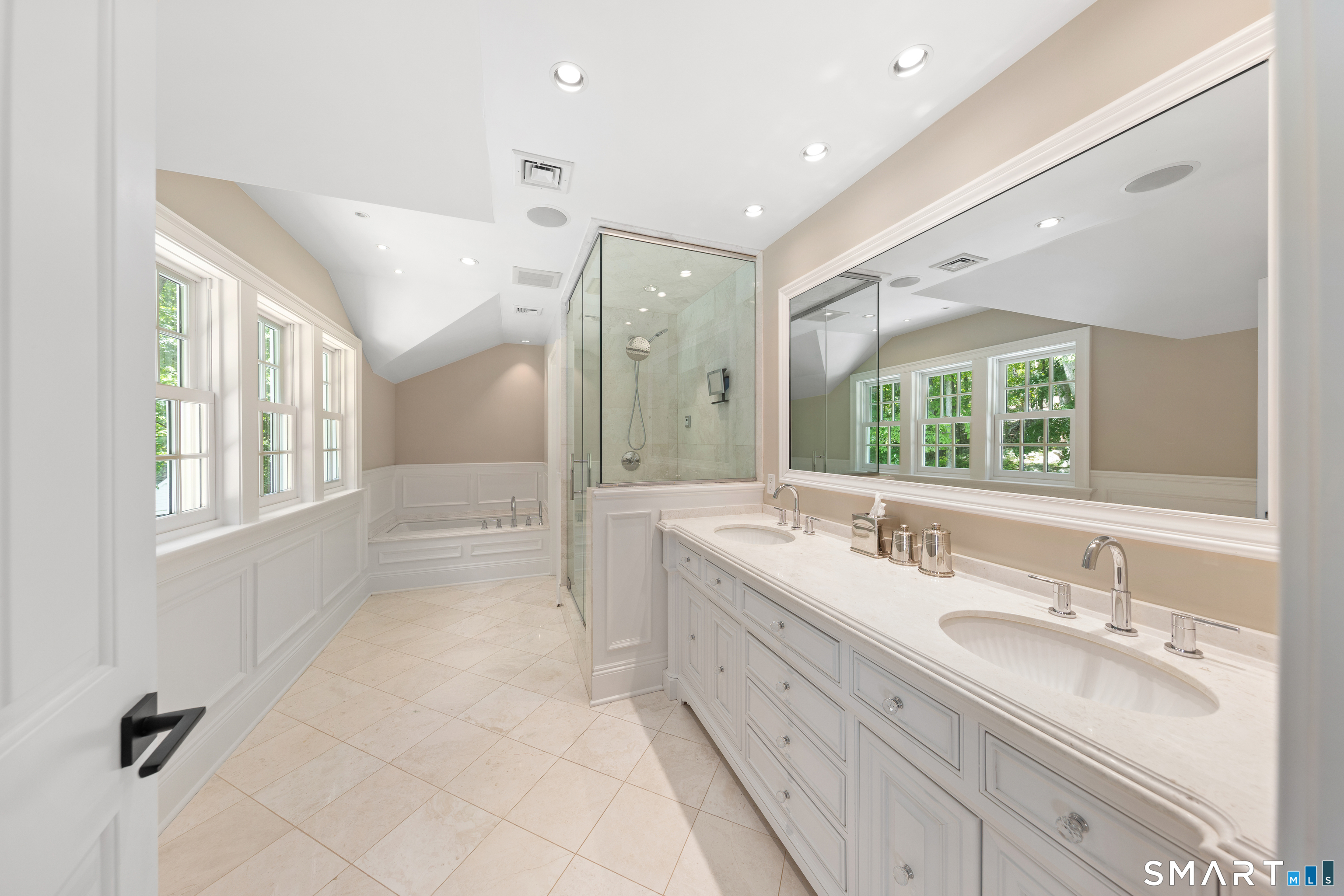 99 Hickok Road New Canaan, CT 06840 - Photo 19 of 39 a bathroom with double vanity sinks a large mirror and a bathtub