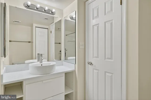 a bathroom with a sink vanity granite tub and shower