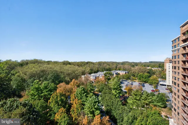 an aerial view of residential houses with city view