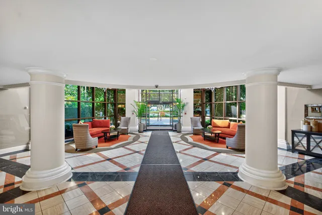 a living room filled with furniture and a floor to ceiling window