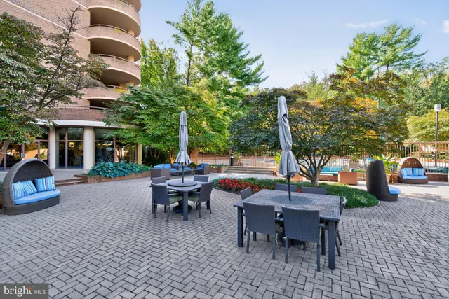 a view of a patio with couches table and chairs and potted plants