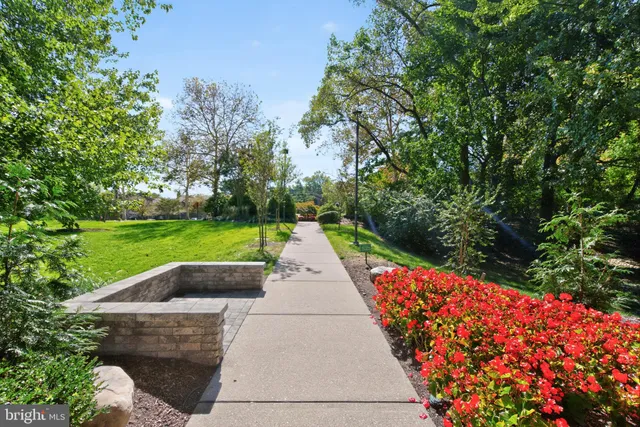 a view of backyard with swimming pool and green space