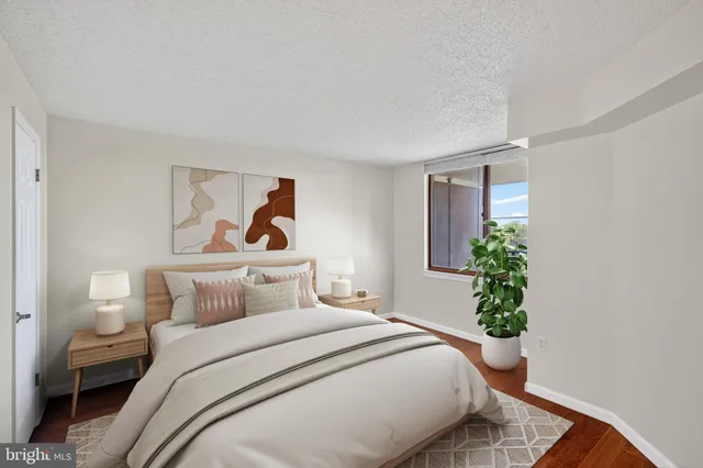 a bedroom with a bed and a potted plant