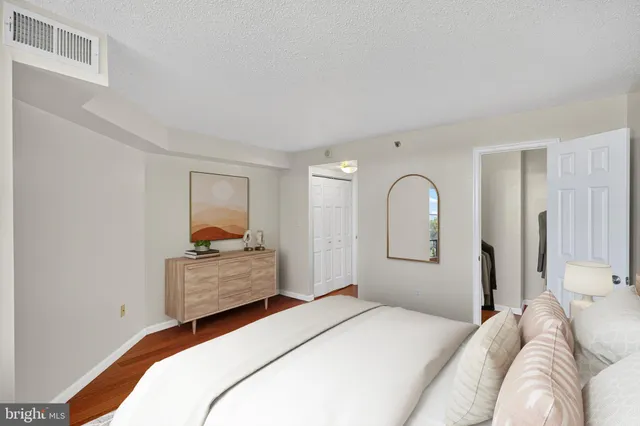 a bedroom with a bed and a dresser