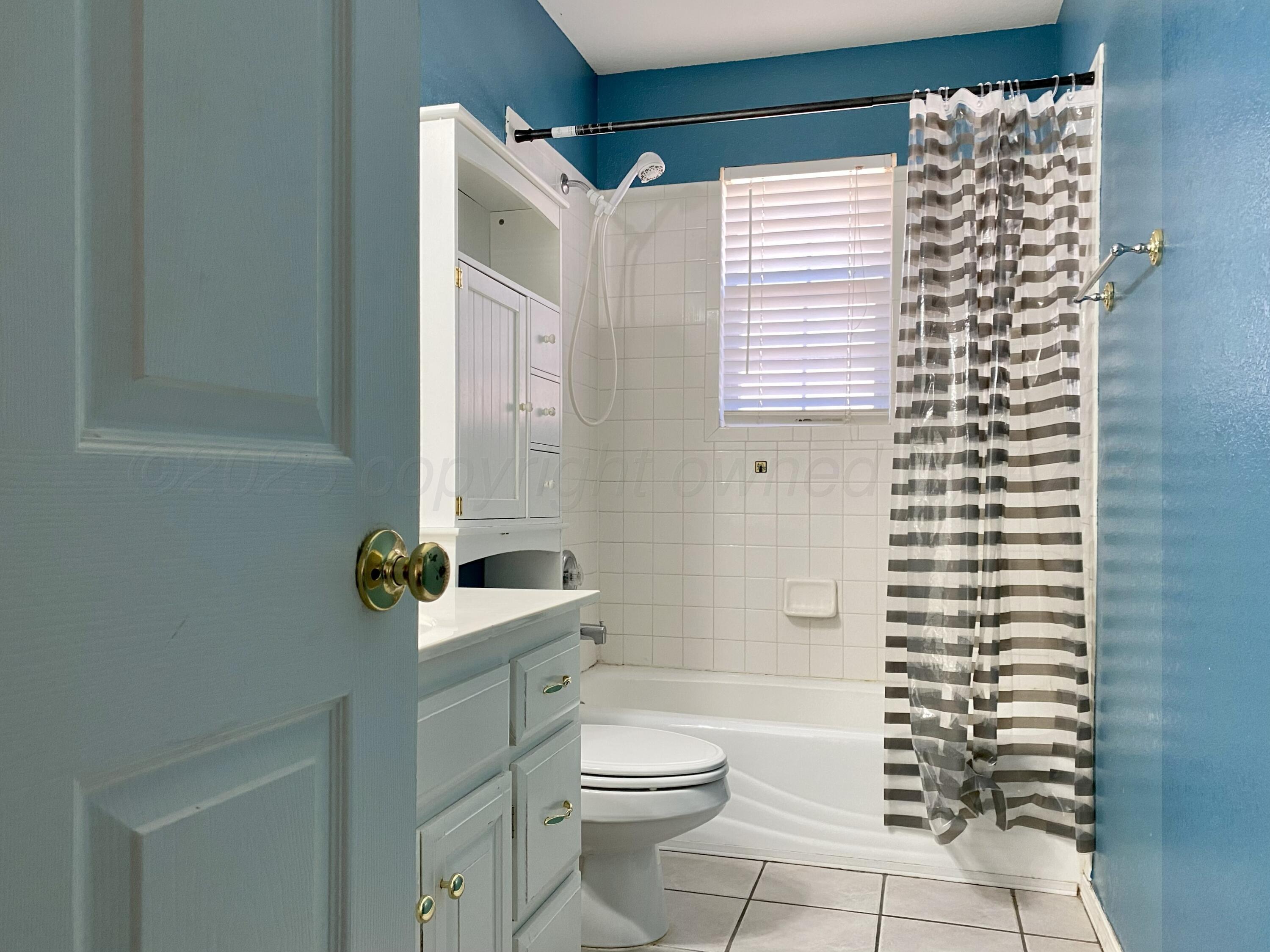 7903 Goal Place Amarillo, TX 79119 - Photo 12 of 14 a bathroom with a sink toilet and shower