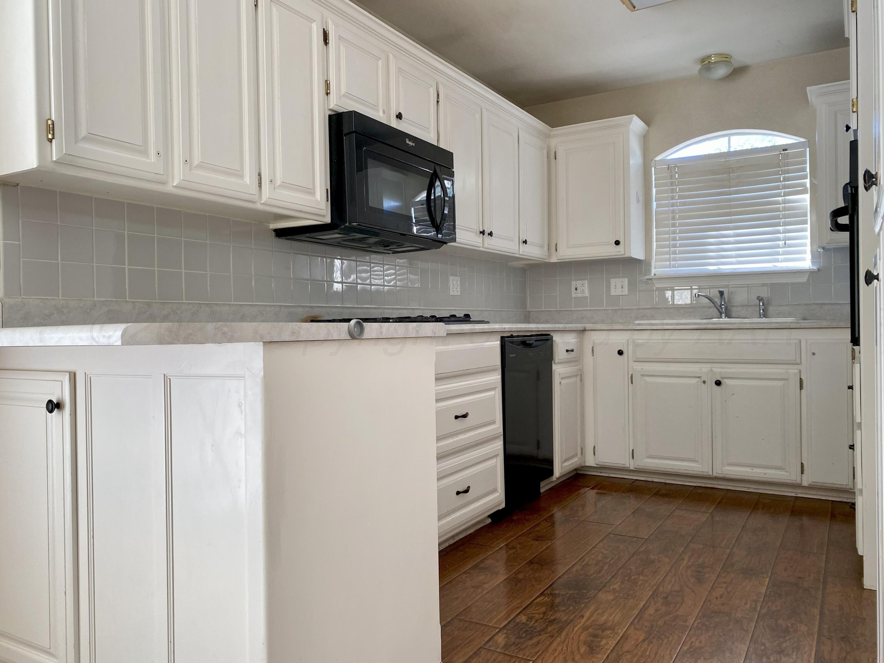 7903 Goal Place Amarillo, TX 79119 - Photo 5 of 14 a kitchen with stainless steel appliances granite countertop a stove a sink and a microwave