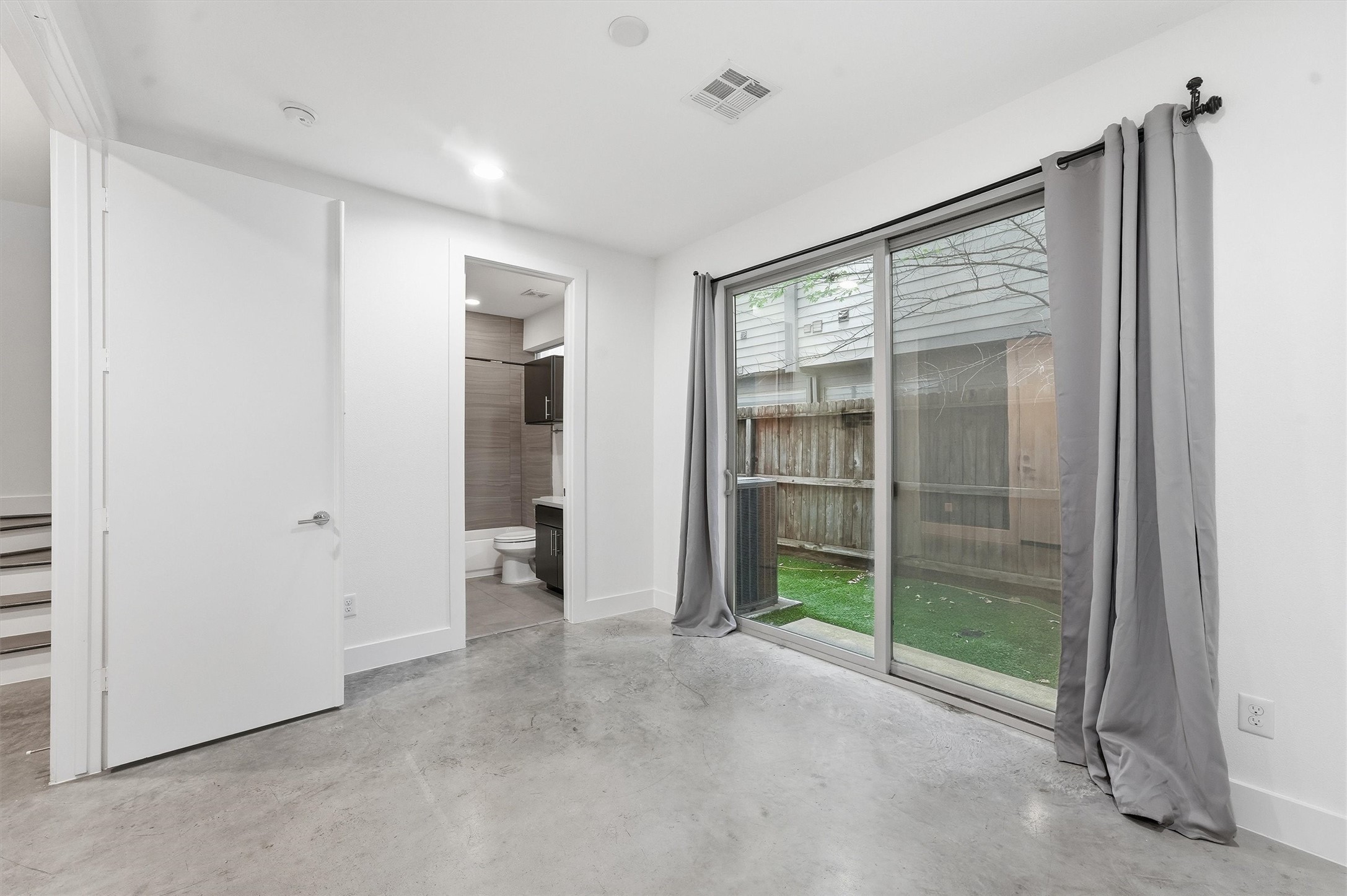 2338 Commerce Street Houston, TX 77003 - Photo 8 of 29 This bright room features double french door entry, polished concrete floors, and a sliding glass door with access to the private outdoor space.