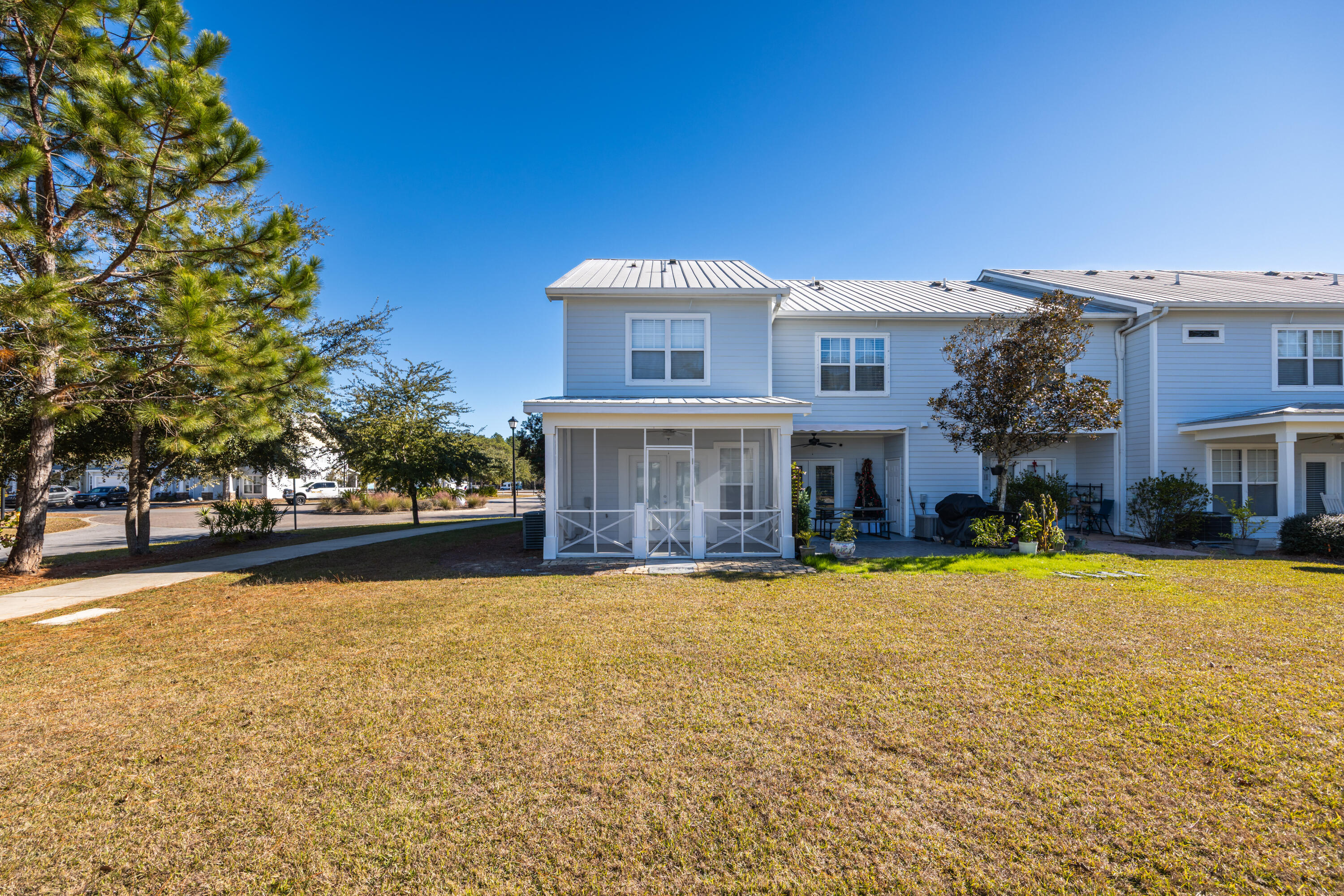 16 South Sand Palm Road Freeport, FL 32439 - Photo 31 of 32 a view of a house with swimming pool and a yard