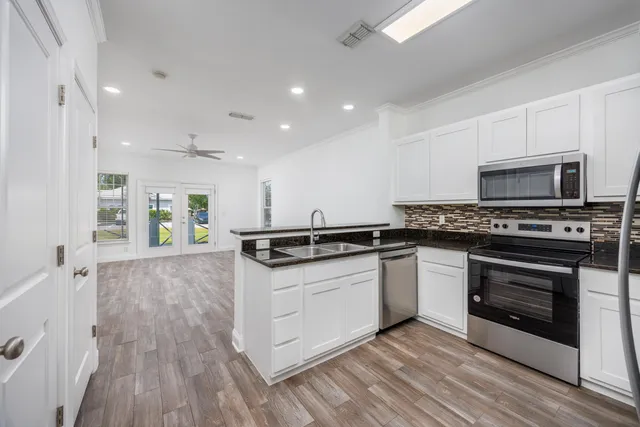 a kitchen with stainless steel appliances granite countertop a stove and a sink