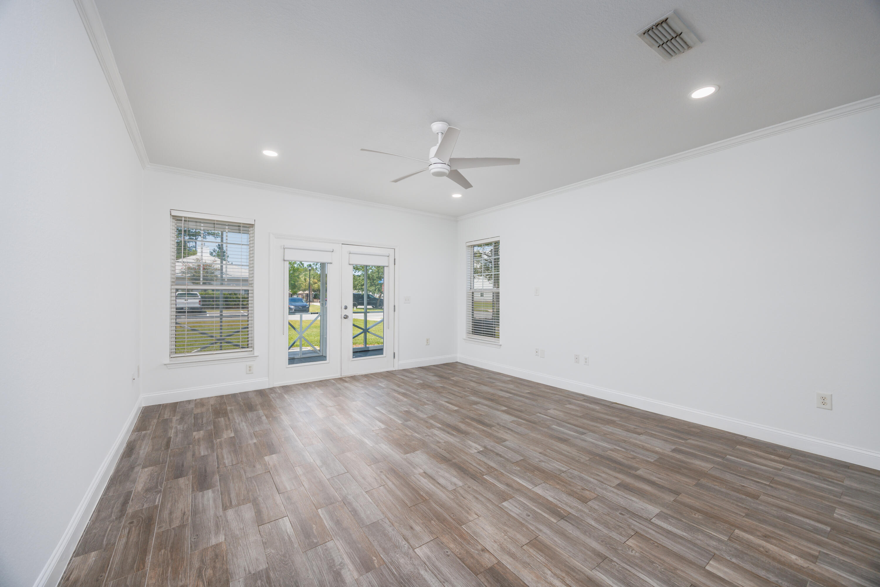 16 South Sand Palm Road Freeport, FL 32439 - Photo 5 of 32 wooden floor in an empty room with a window