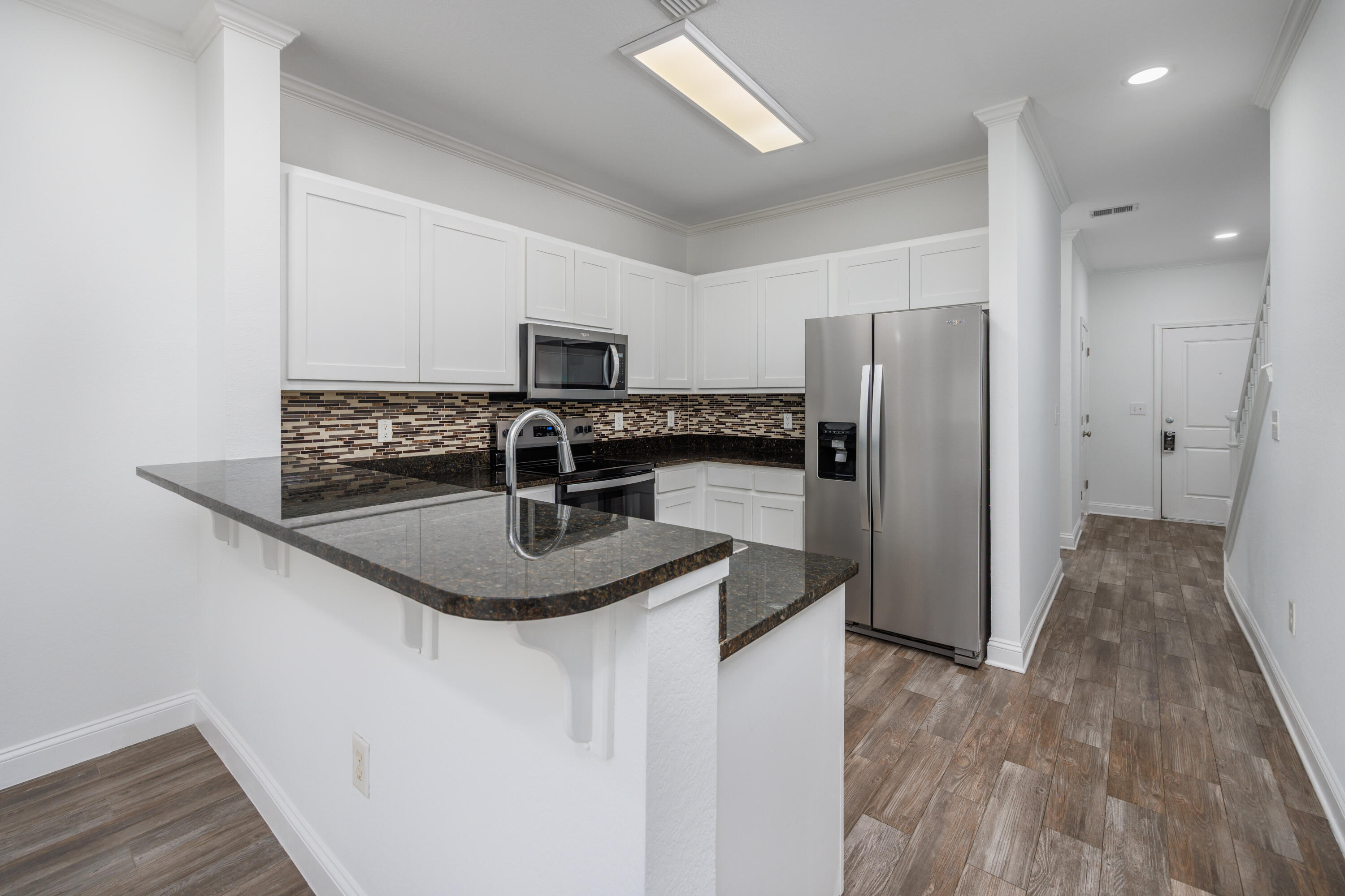 16 South Sand Palm Road Freeport, FL 32439 - Photo 6 of 32 a kitchen with stainless steel appliances granite countertop a sink stove and refrigerator