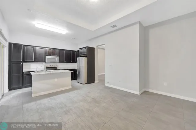 a kitchen with refrigerator cabinets and stainless steel appliances