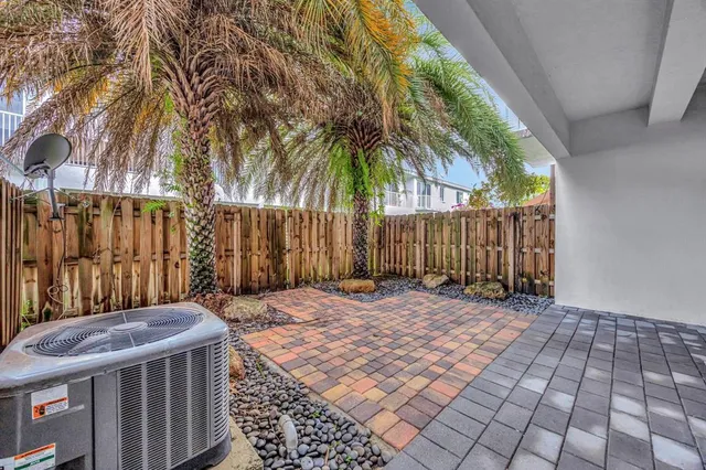 a backyard of a house with table and chairs
