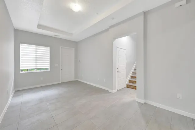an empty room with windows and closet