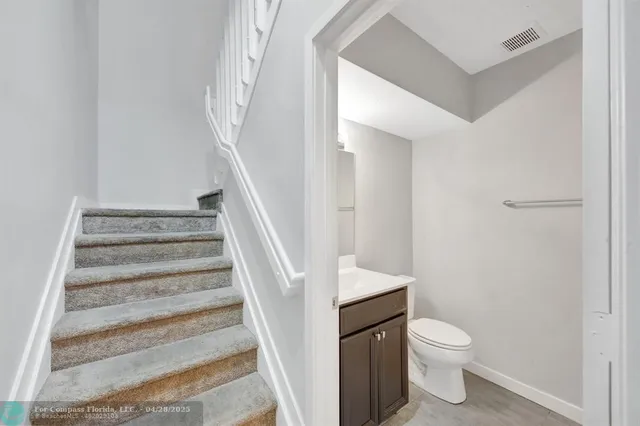 a bathroom with a sink toilet and vanity