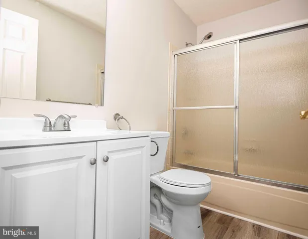 a bathroom with a toilet a sink and shower