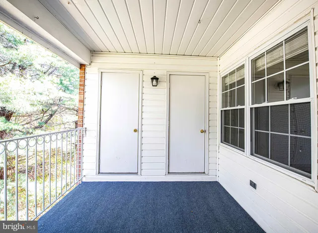 a view of an entryway with wooden floor and door