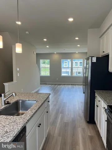 a view of a living room with furniture and wooden floor