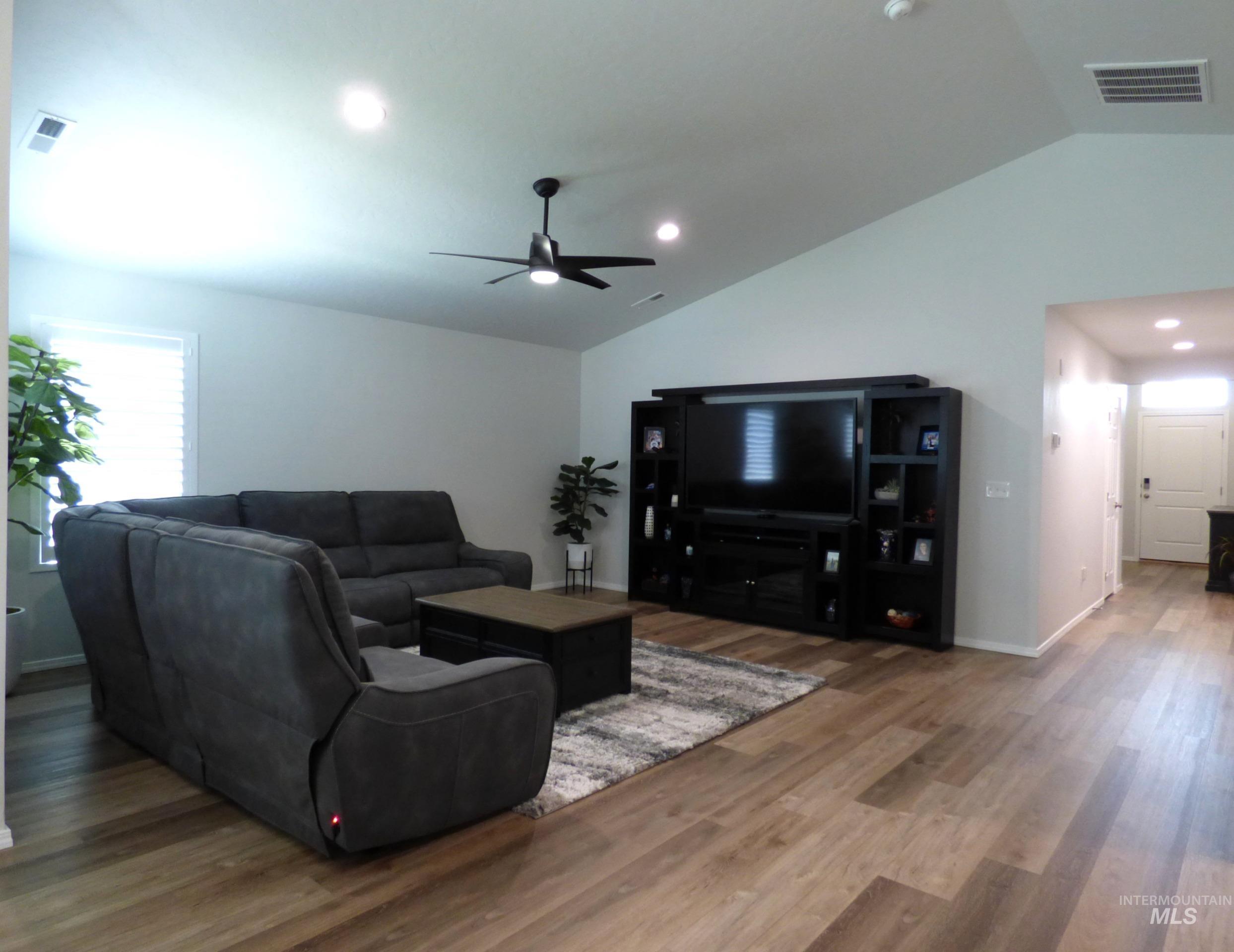 2708 East Buckaroo Drive Kuna, ID 83634 - Photo 13 of 48 Vaulted ceiling living room featuring wood-finish flooring, recessed lighting, and a contemporary ceiling fan