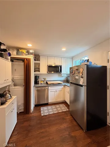a kitchen with a refrigerator a stove top oven a counter space and cabinets