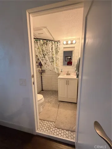 a bathroom with a granite countertop sink a washer and dryer