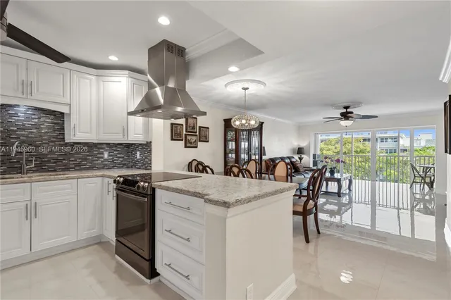 a kitchen with stainless steel appliances granite countertop a stove oven and white cabinets