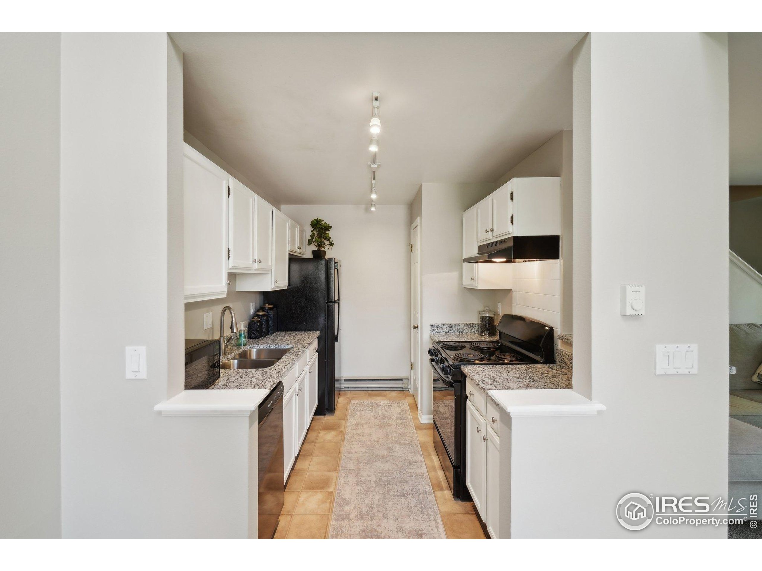 1601 West Swallow Road, Unit 9 Fort Collins, CO 80526 - Photo 14 of 33 a kitchen with stainless steel appliances a stove a sink a refrigerator and cabinets
