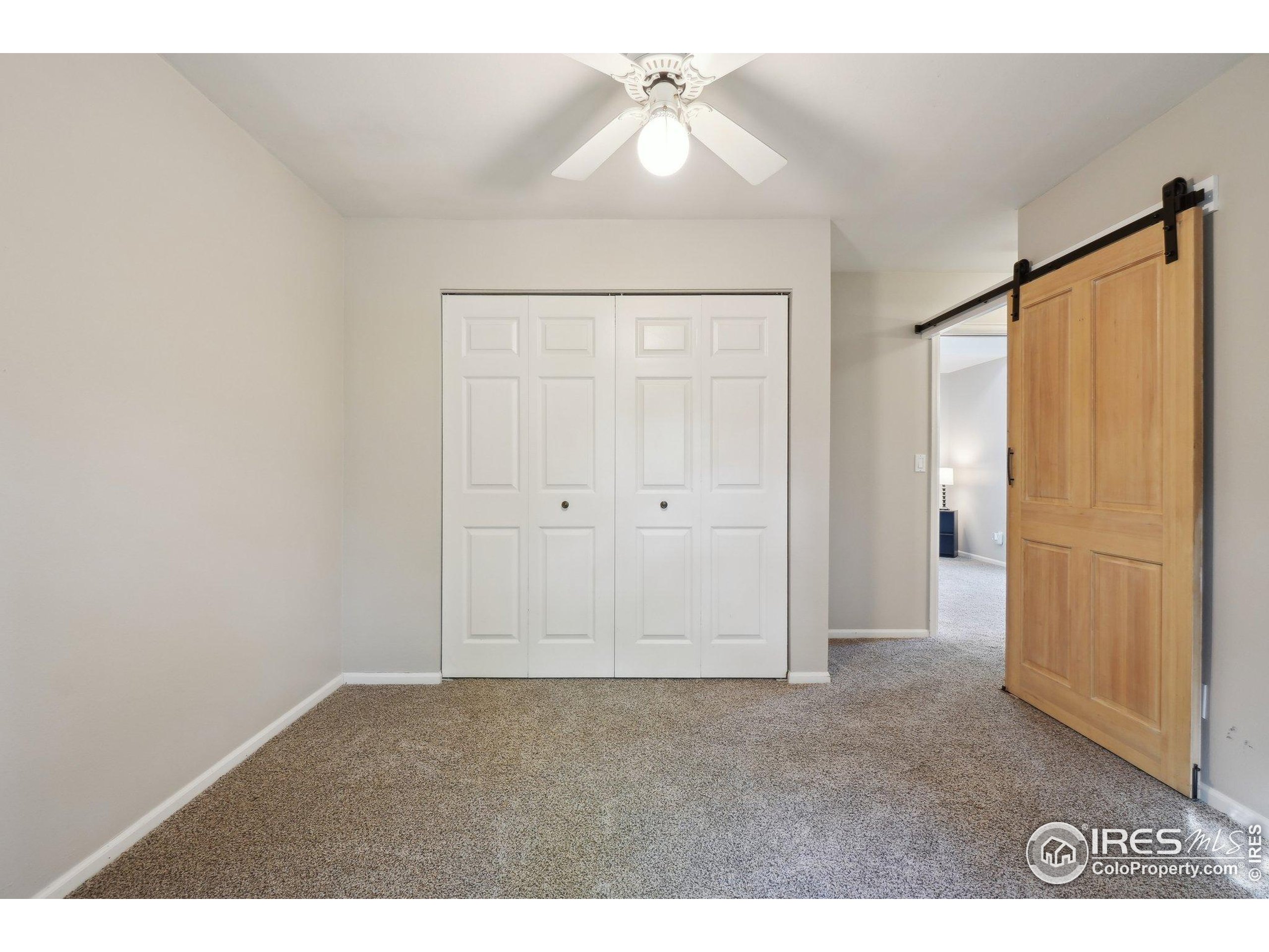 1601 West Swallow Road, Unit 9 Fort Collins, CO 80526 - Photo 16 of 33 a view of an empty room with a ceiling fan