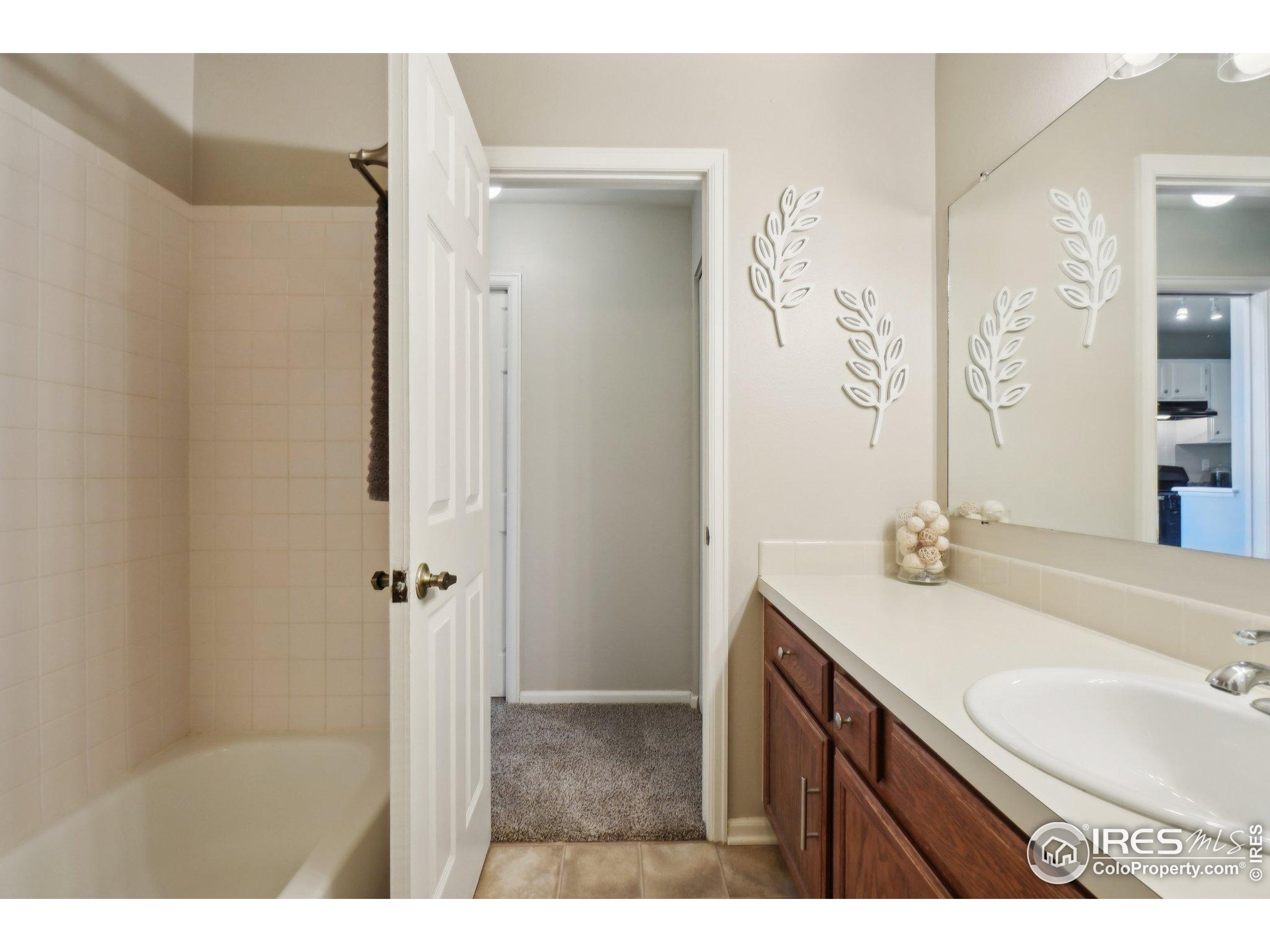 1601 West Swallow Road, Unit 9 Fort Collins, CO 80526 - Photo 21 of 33 a bathroom with a sink and a mirror
