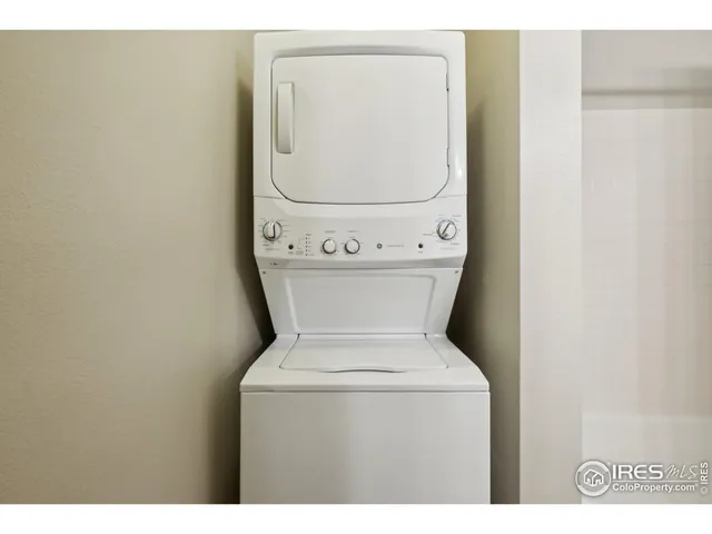 a spacious bedroom with a large bed and a chandelier