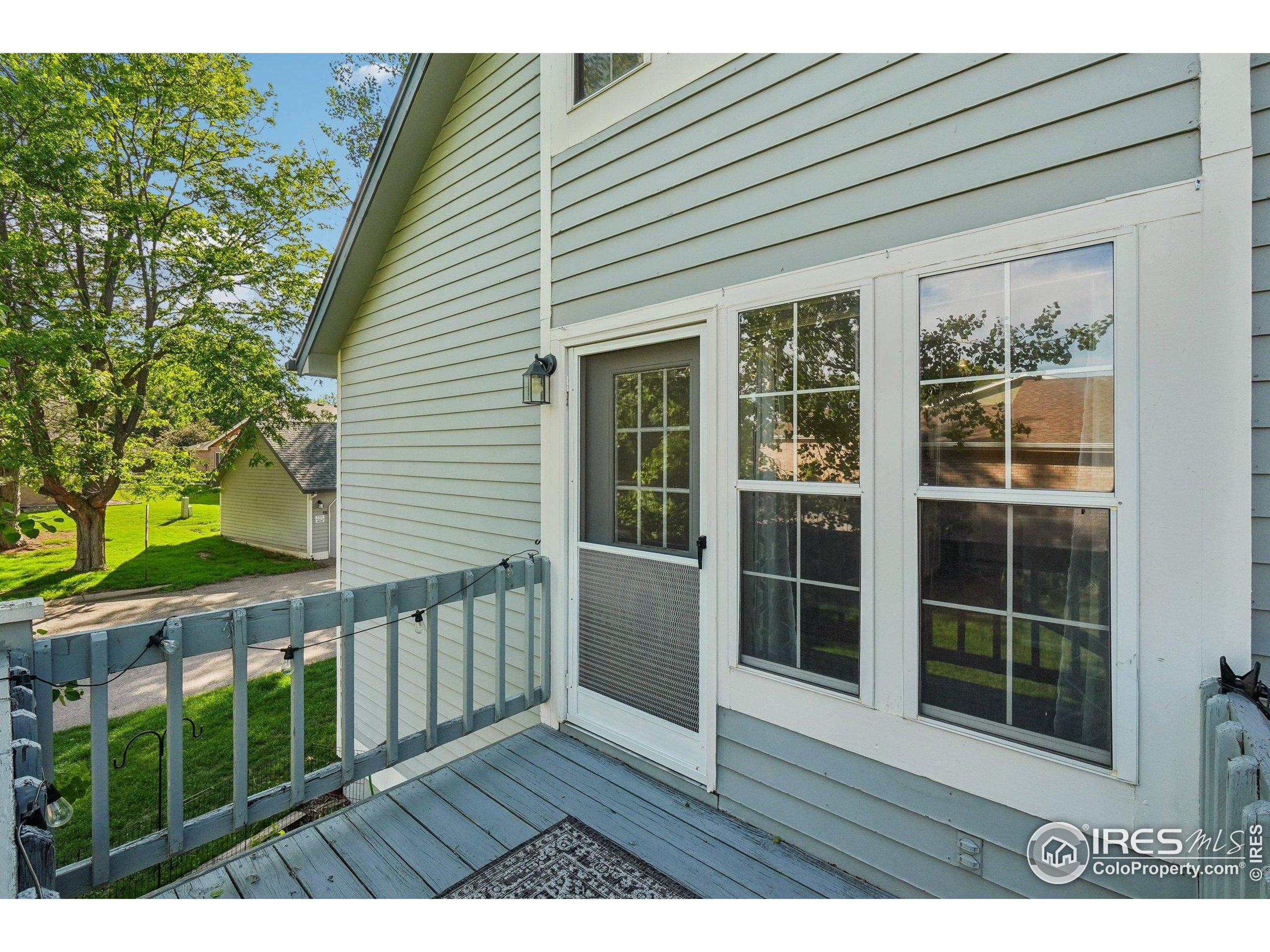 1601 West Swallow Road, Unit 9 Fort Collins, CO 80526 - Photo 29 of 33 a view of an empty room with wooden floor and fence