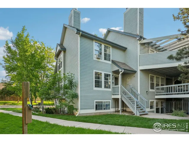 a view of a house with a yard and potted plants
