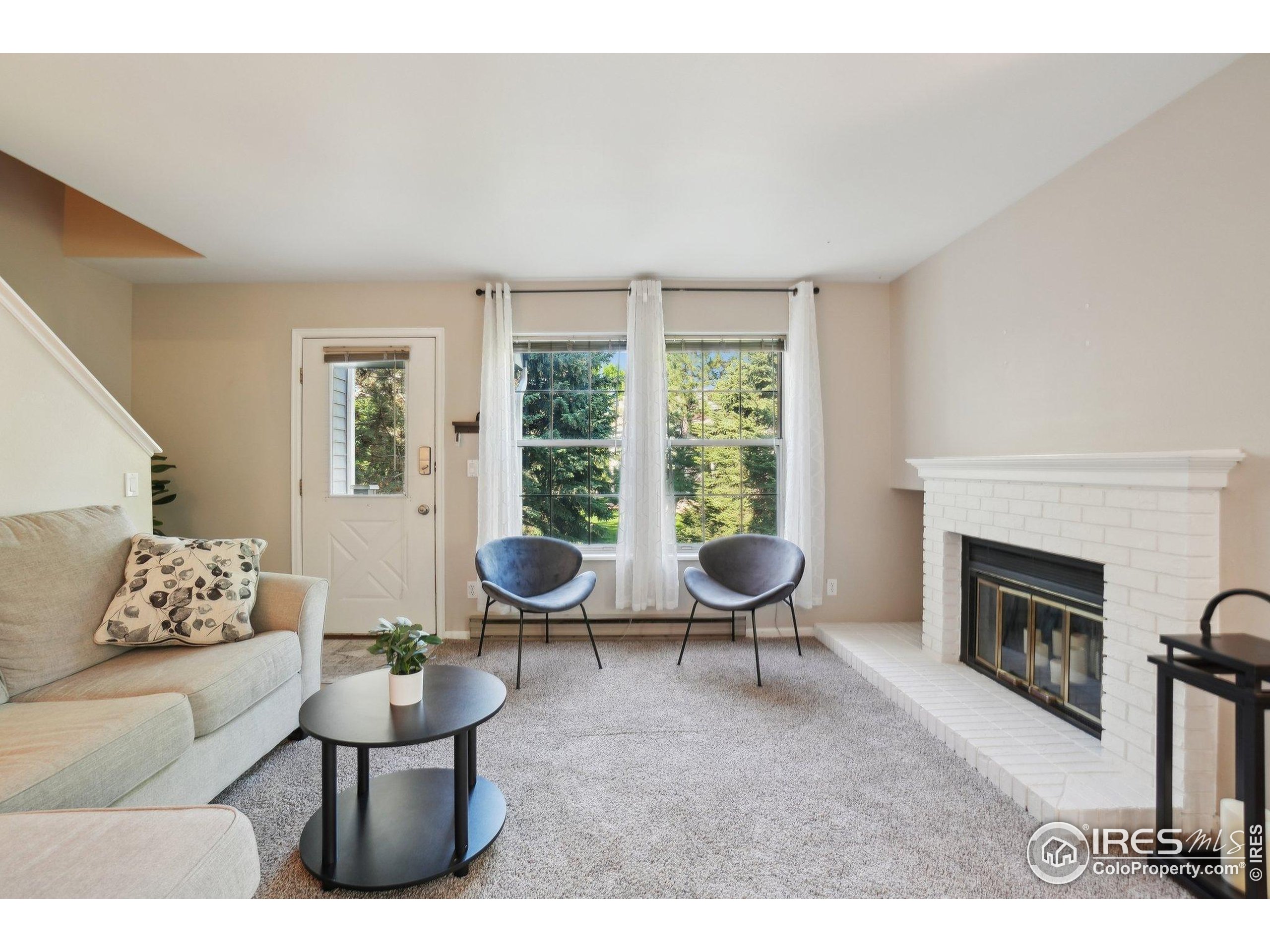 1601 West Swallow Road, Unit 9 Fort Collins, CO 80526 - Photo 9 of 33 a living room with furniture and a fireplace