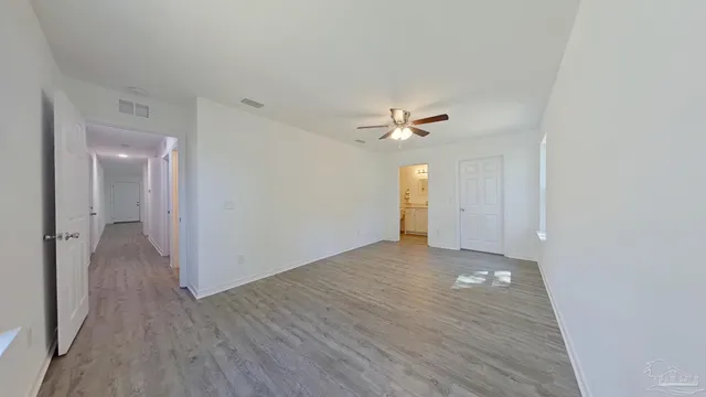 a view of an empty room and wooden floor