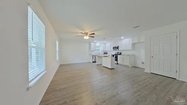 a view of kitchen with wooden floor